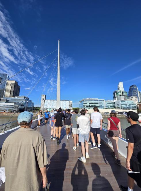 a group of students walking across a bridge in Buenos Aires