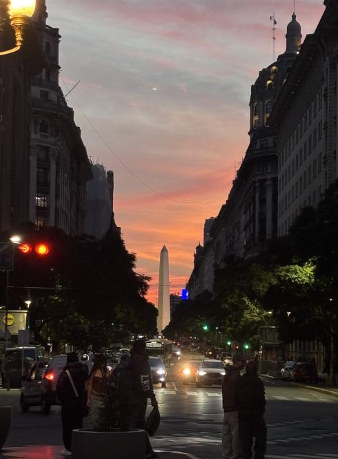 cars driving by during sunset downtown Buenos Aires, in front of the Obelisco monument