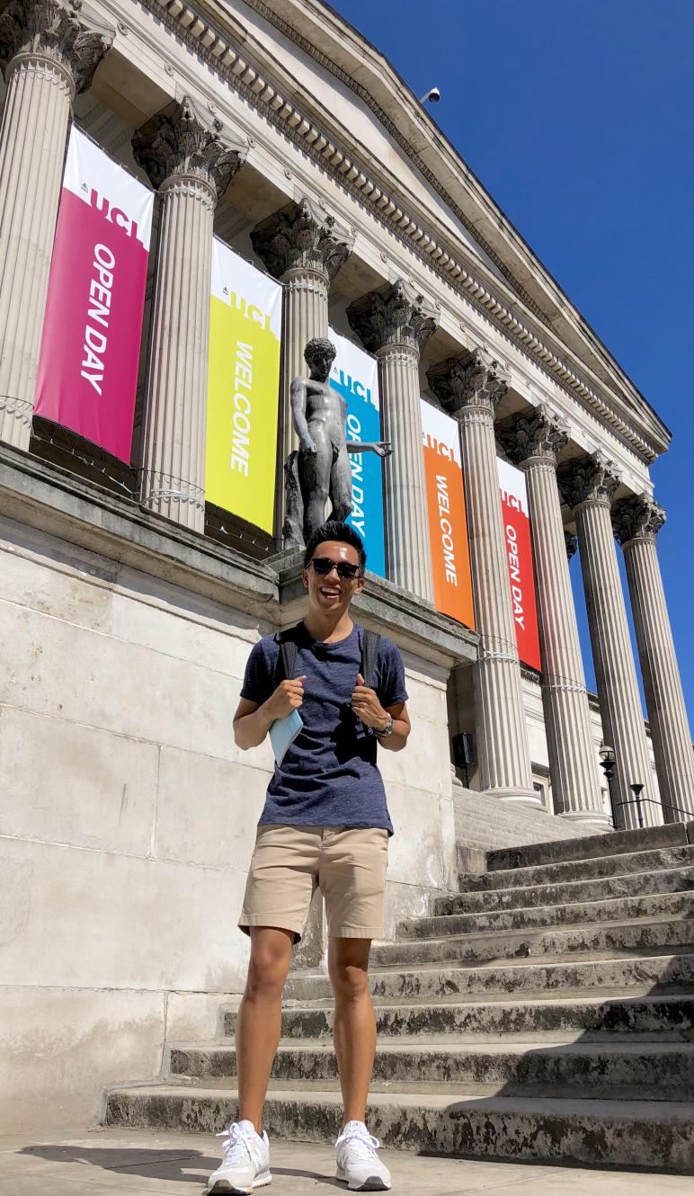 a student standing on the steps of University College London