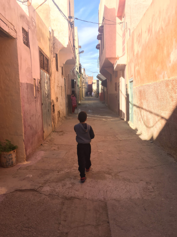 Brahim walking down a Medina street