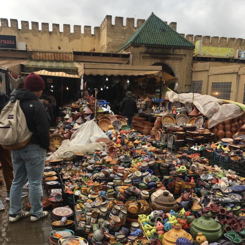 a pile of pottery in a market
