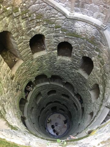 A stone well descending