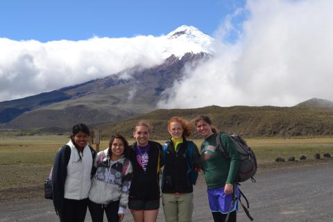 students pose in front of snow-capped mountain