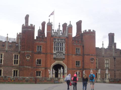 students walking into brick building with turrets in England