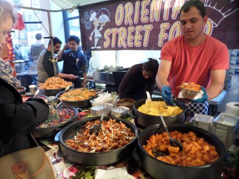 street food table with bowls full of chicken and rice