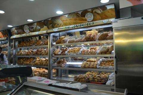 inside of a panaderia with bread-filled shelves