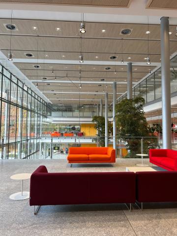 Red couches inside glass building 
