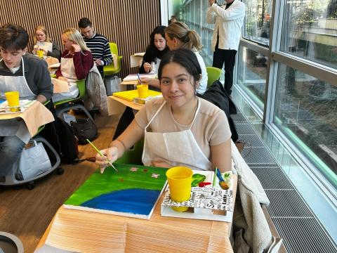 Milan student smiling at paint and sip class