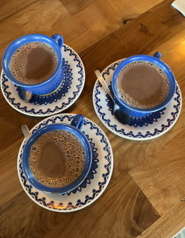 three cups of hot chocolate in blue ceramic cups