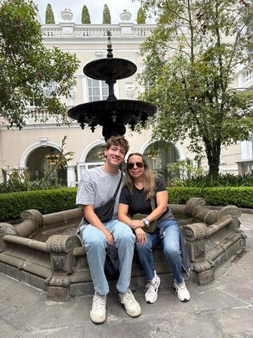 My host mother and I sitting on the ledge of a fountain in the middle of a garden in Quito.