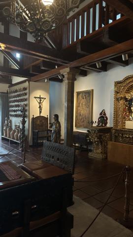 interior Guayasamín Museum; dark wooden statues and religious art
