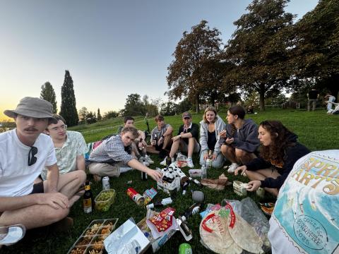 People sitting on the ground for a picnic