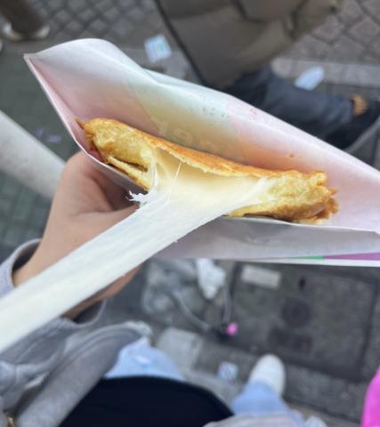 This is a photo of the cheese pull from a coin-shaped cheese-filled bread called 십원빵.