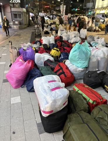 This is a photo of bags of clothes outside in Dongdaemun.
