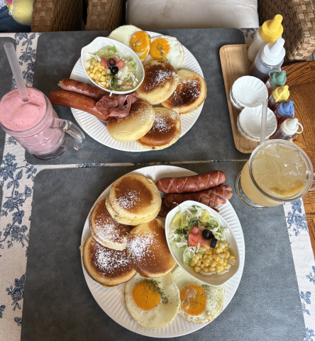 This is a photo of the breakfast pancakes, sausage, and eggs eaten at a nearby brunch location.