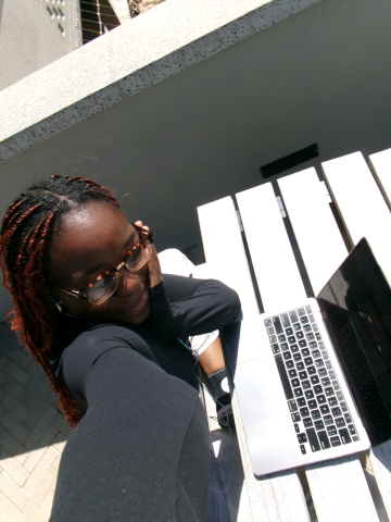 Picture on a sunny day of me and my computer studying at a table. 