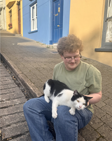 A black and white cat on the author's lap