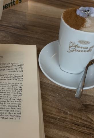 A chai latte and a book at Artesanos de Granada
