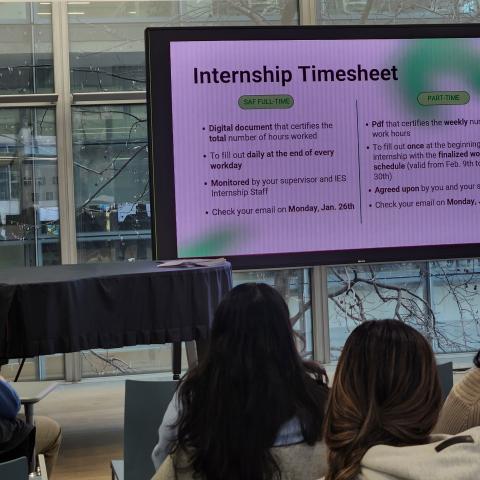 Presentation slide titled “Internship Timesheet” displayed on a screen during an orientation session