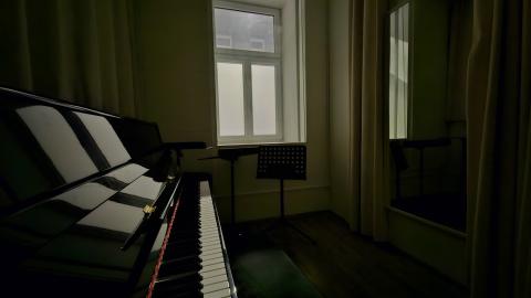 A dark, calm image inside a practice room of IES Vienna's Practice Facility.