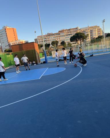 This beautiful basketball court has a beautiful backdrop of old Spanish apartment buildings.