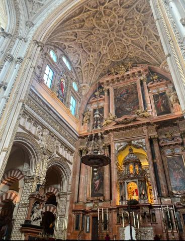 The interior of the Mosque of Córdoba, highlighting both the Islamic arches and Catholic effigies