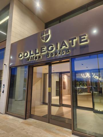 The entrance of Collegiate Milan Bovisa with keycard access doors and a reception area.