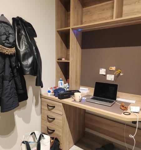 A desk and chair setup for studying inside a studio room at Collegiate Milan Bovisa.
