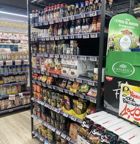 A bunch of soysauce and noodles on a shelf