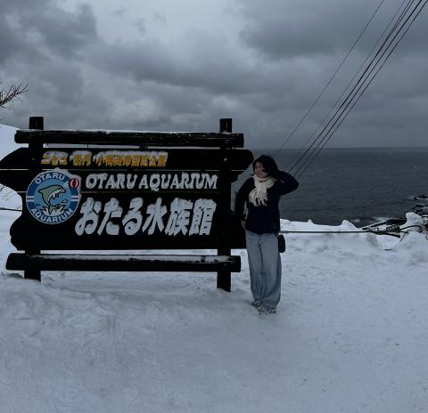 Me posing in front of the Otaru Aquarium sign