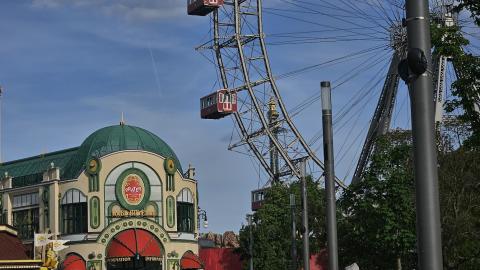 A clear blue Vienna sky, showing the entrance to Prater, just below the Vienna Giant Ferris Wheel.