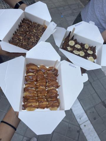 Three boxes of mini pancakes with nutella and dulce de leche topping