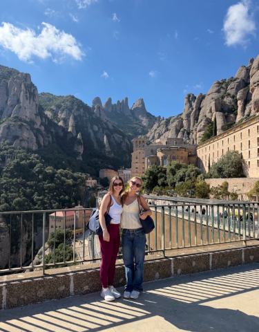 Two girls standing in front of view of mountain