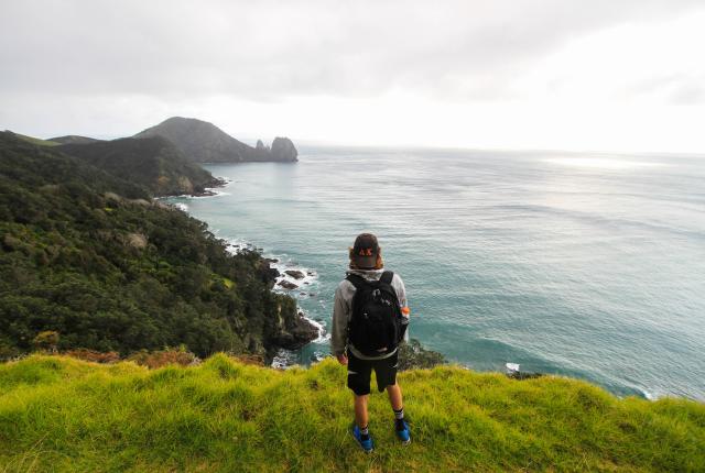 a student looks out over New Zealand's coast