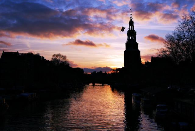 An Amsterdam canal and guard tower at dusk