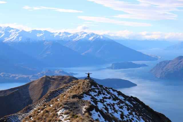 a student poses for a panoramic photo at Roy's Peak in New Zealand's South Island