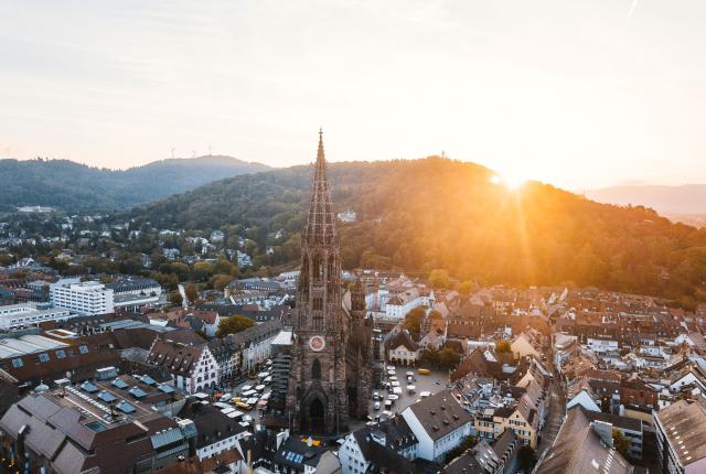 an aerial view of Freiburger Münster cathedral at sunset