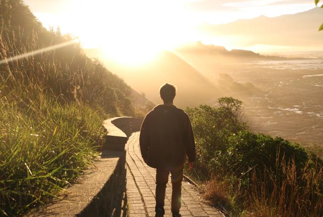 a student taking a coastal sunride hike in Kaikoura, New Zealand