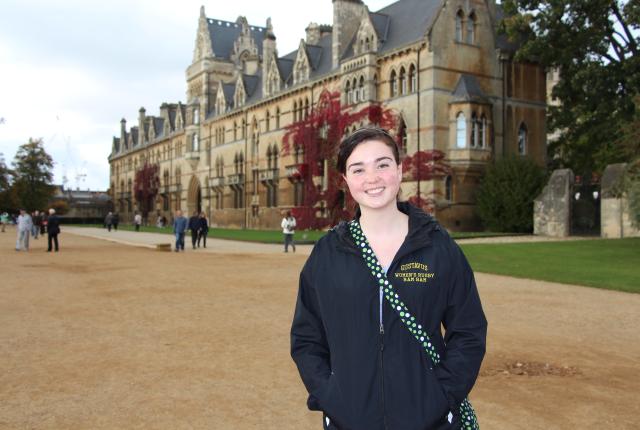 a student posing for a photo in front of Christ Church Cathedral in Oxford