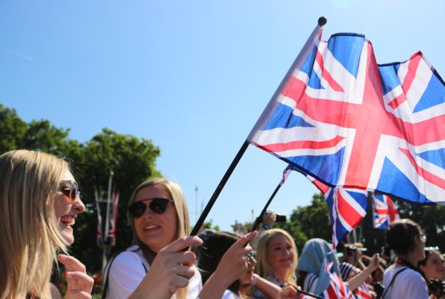 students waving British flags in the summer sun