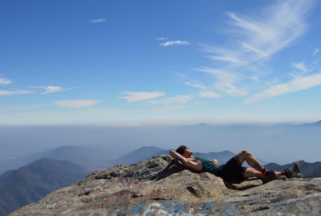 a student takes a rest atop a mountain in the Andes in Chile
