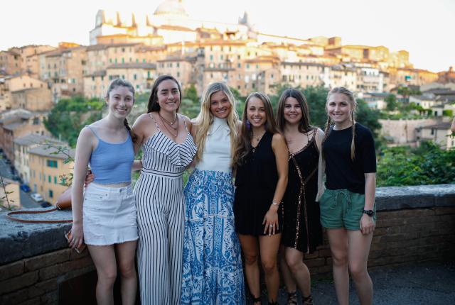 a group of students pose for a photo in Siena
