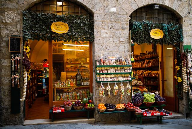 a corner store in Siena decorated with food and wine