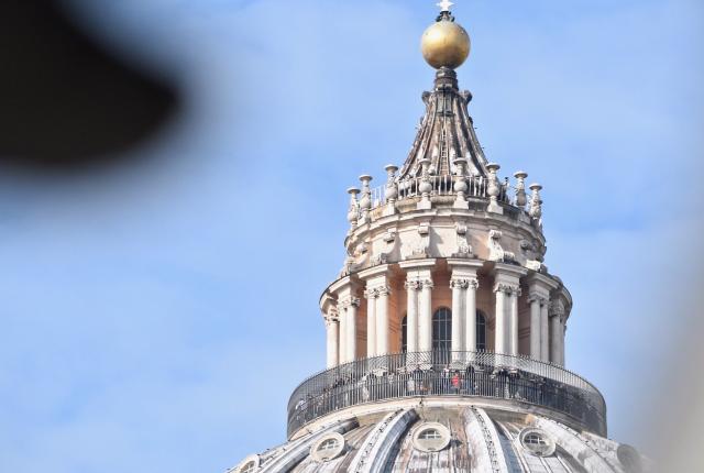 a cross atop a dome at the Vatican