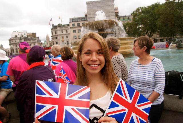 a student posing for a photo with the UK flag