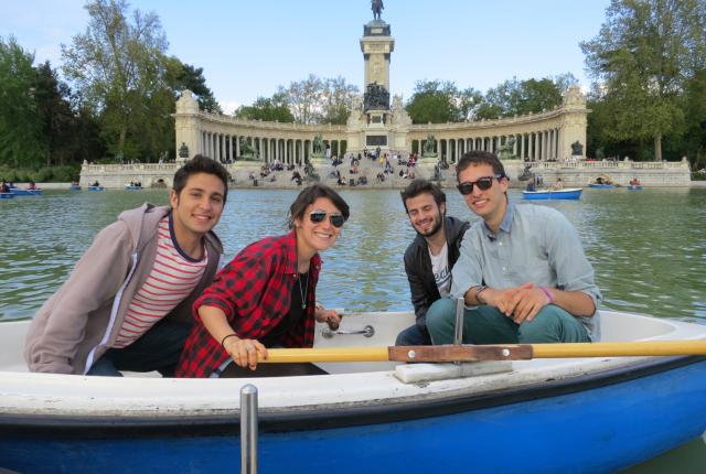 students pose for a photo while in a boat at Retiro Park Lake in Madrid