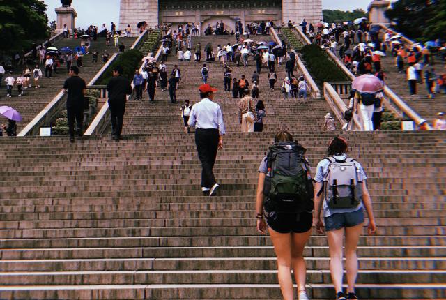 shanghai students walking up the steps toward a mausoleum