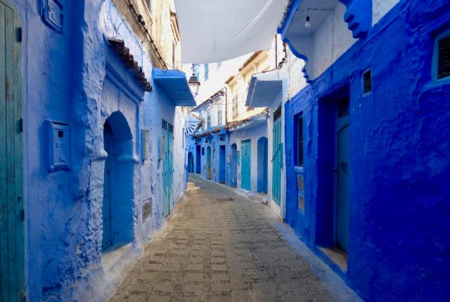 A street of blue buildings in Chaouen, Morocco.