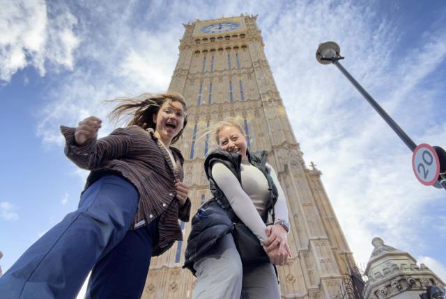 Two students smile in front of Big Ben.