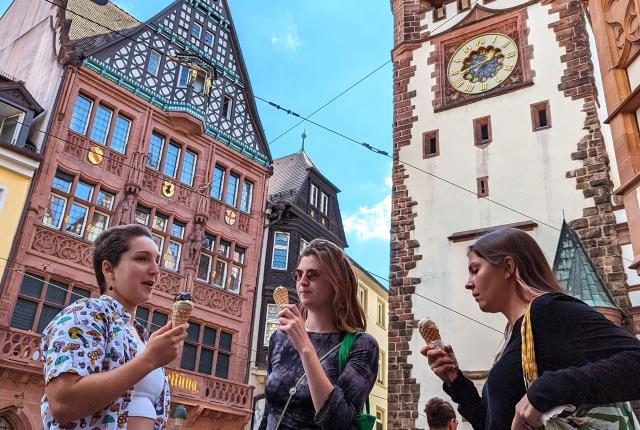 students standing eating ice cream surrounded by German architecture